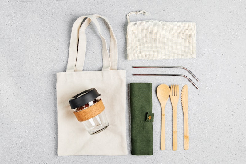 Set of Eco friendly bamboo cutlery, eco bag and reusable coffee mug. Sustainable lifestyle. Plastic ...