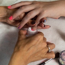 Everything to know about giving yourself a dip powder manicure at home, including prepping, applying...