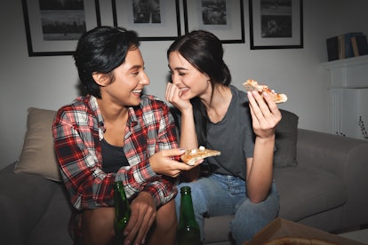 Two women celebrating their four-month anniversary with pizza.