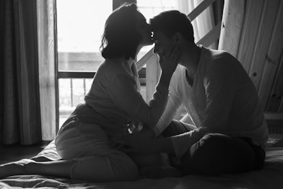 Young couple kissing  in bed.Black and white photo 
