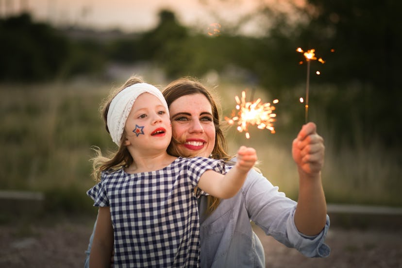 Mother and daughter enjoy Fourth of July sparklers together