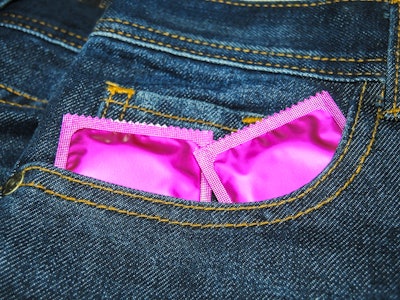 Condoms for sex.Jeans background.A good image to use.Close shot.