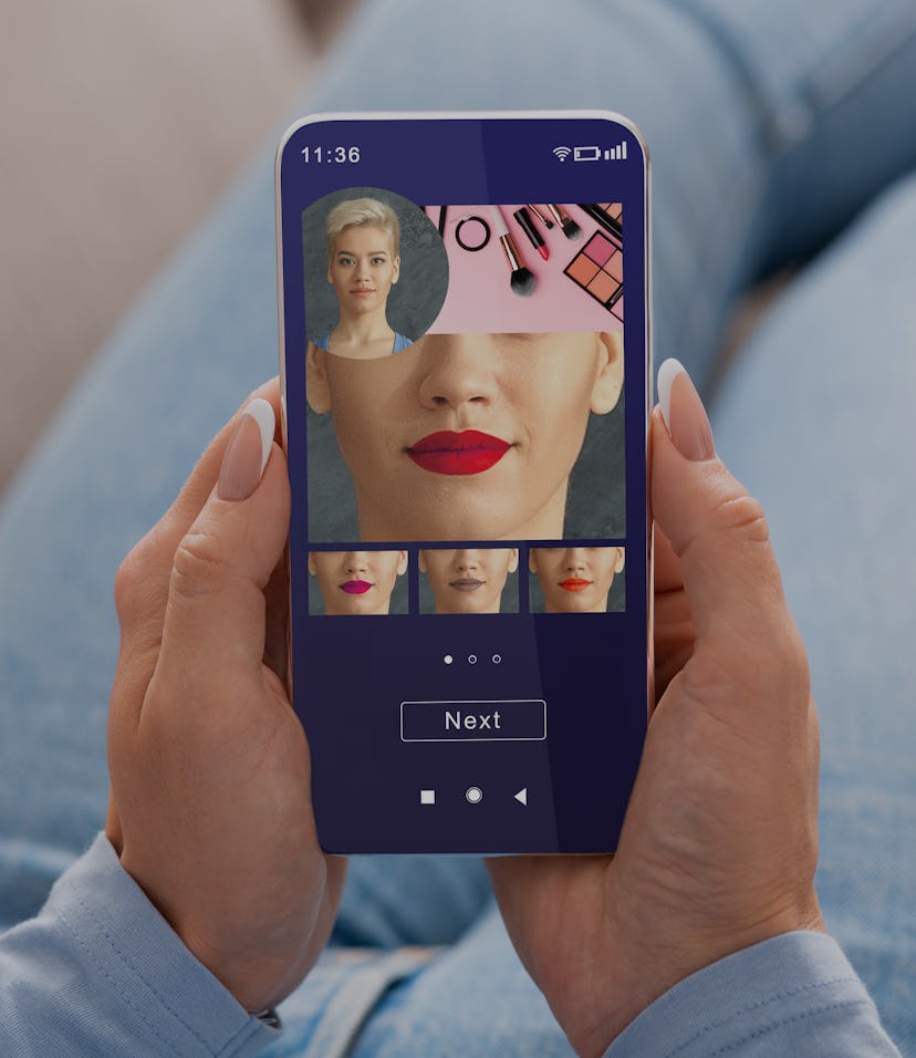 Augmented Reality Beauty App. Woman Trying Different Lipstick Color Online On Smartphone, Using Mode...