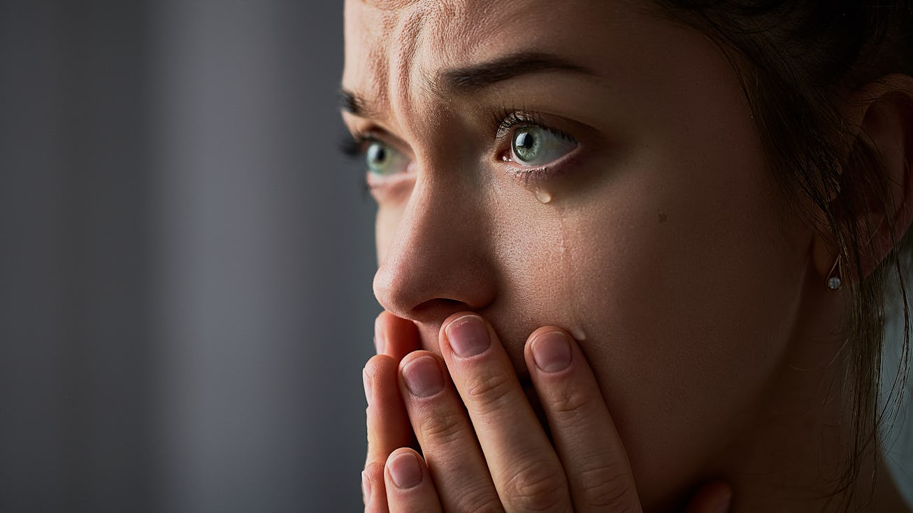 Sad desperate grieving crying woman with folded hands and tears eyes during trouble, life difficulti...