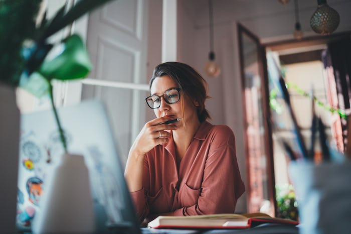 woman sitting at desk looking at computer