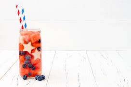 Red, White and Blue lemonade or sangria. Patriotic drink cocktail with watermelon, blueberry and app...