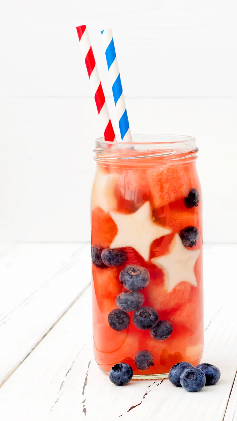 Red, White and Blue lemonade or sangria. Patriotic drink cocktail with watermelon, blueberry and app...