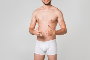 partial view of man in white underwear showing thumbs up isolated on grey