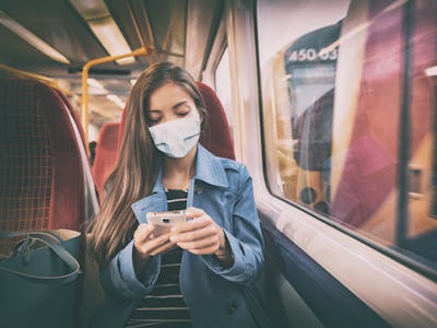 Face mask concept. Woman wearing mandatory mask inside public spaces for transport such as train sta...