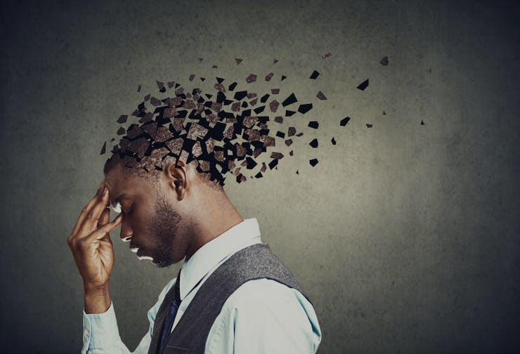 Memory loss due to dementia or brain damage. Side profile of a sad man losing parts of head as symbo...