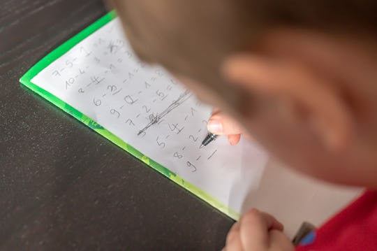 A child practices math problems.