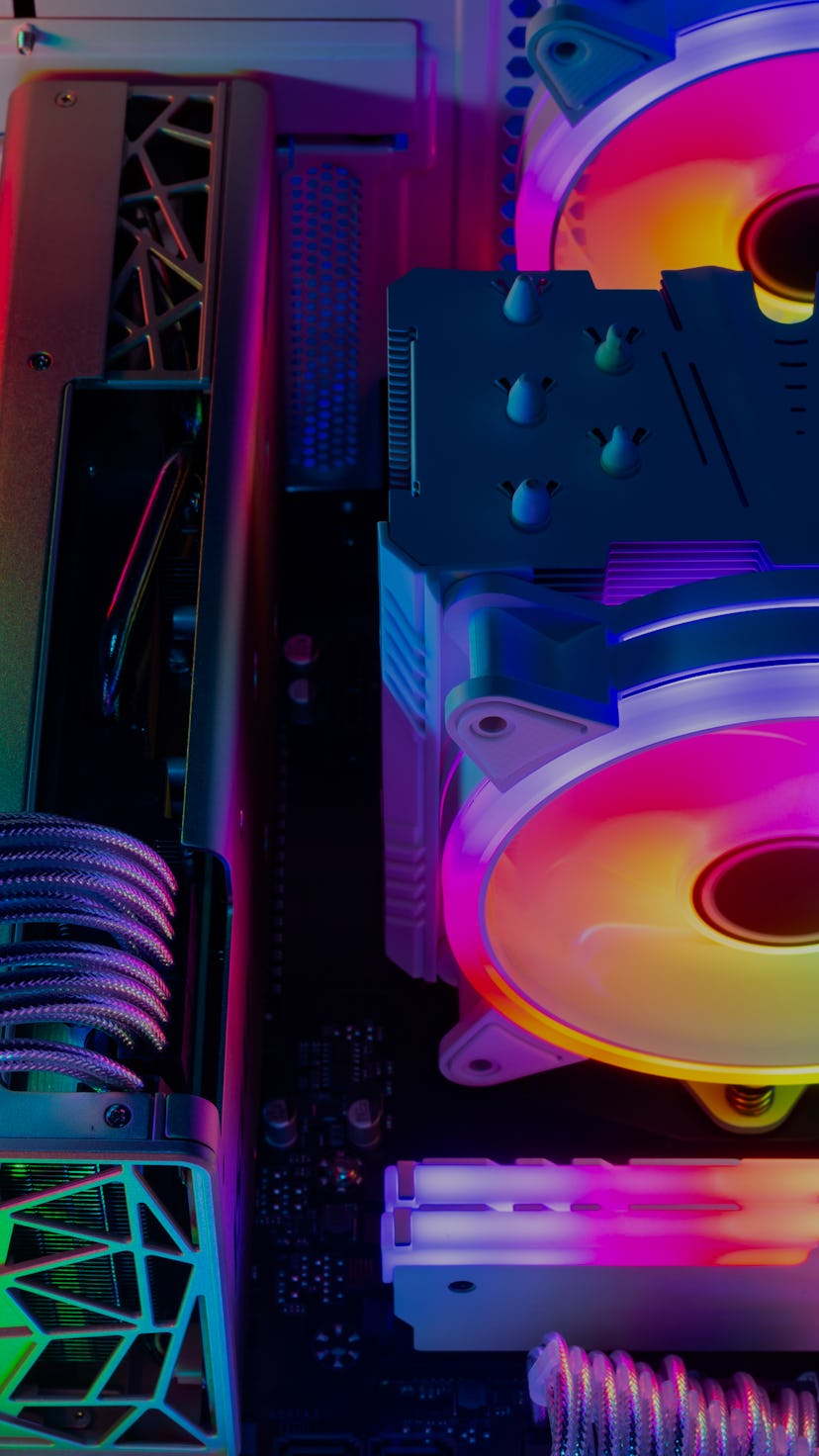 Inside view of custom colorful illuminated bright rainbow RGB LED gaming pc.. Computer power hardwar...