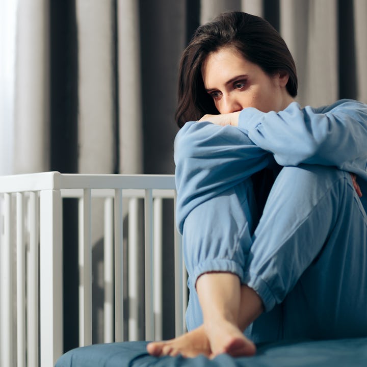 A woman mourning the loss of her infant due to still birth. Moms who have experienced still births a...