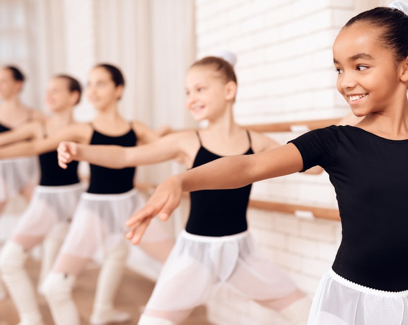 Young ballerinas rehearsing in the ballet class; extracurricular activities for kids
