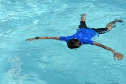 floating body of a drowned male children in swimming pool. concept of safety