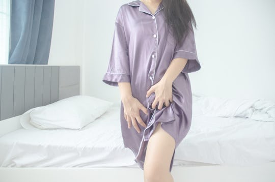 woman wearing a purple nightshirt in article about why is my vagina itchy