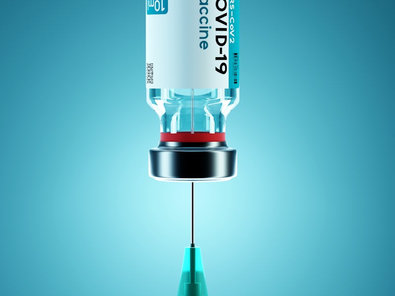 SARS - CoV2 Vaccine concept. A medical needle entering into a glass vial of COVID-19 Vaccine. Medica...