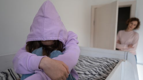 Anxious mom worry about introvert teen daughter hiding in hood, suffer from school discrimination bu...