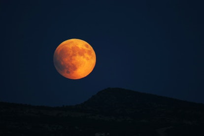 Super moon rising over hills prior to full eclipse