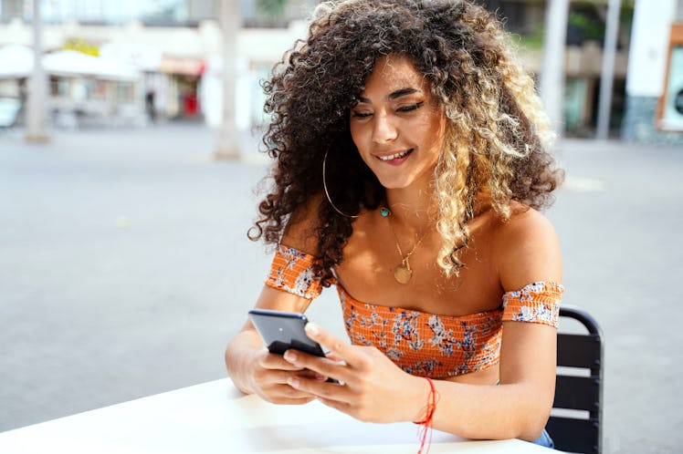 Woman sexting on phone by zodiac sign.