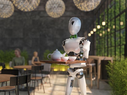 A humanoid robot waiter carries a tray of food and drinks in a restaurant. Artificial intelligence r...