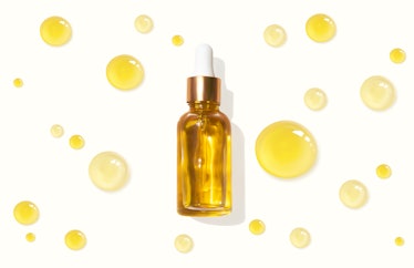 Oil serum glass bottle and collagen drops realistic vector illustration, top view. Aromatherapy oil....