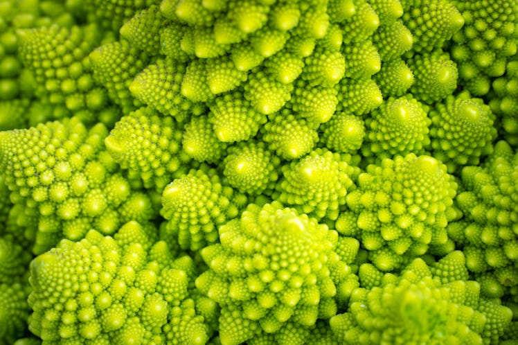Romanesco cabbage head close-up. Vegetable background of green cabbage. The variety of cabbage Roman...