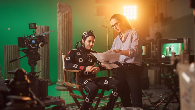 On Film Set: Prominent Female Director Explains Scene to Male Actor Wearing Motion Capture Suit and ...