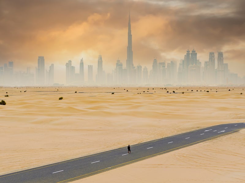 View from above, stunning aerial view of an unidentified person walking on a deserted road covered b...