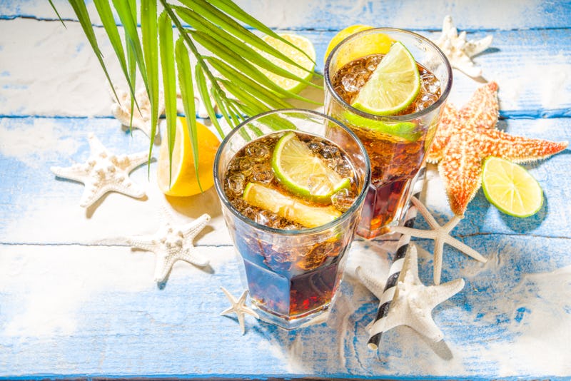 Summer holiday vacation tropical background with iced beverages. Cuba Libre, long island iced tea co...