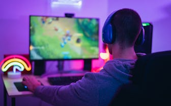 Young gamer playing online video games while streaming on social media - Youth people addicted to ne...