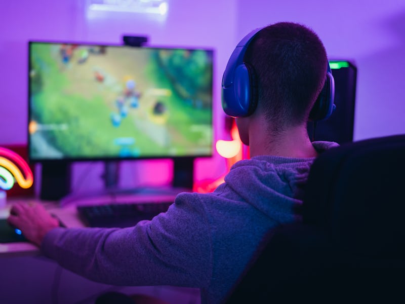 Young gamer playing online video games while streaming on social media - Youth people addicted to ne...