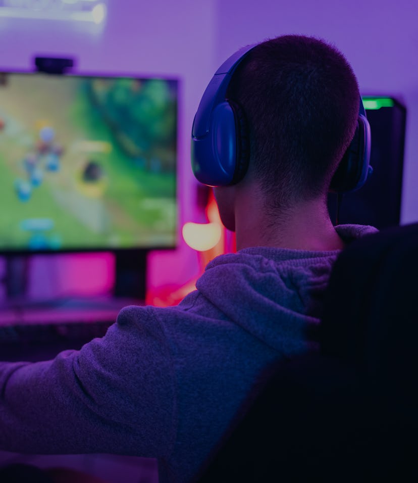 Young gamer playing online video games while streaming on social media - Youth people addicted to ne...