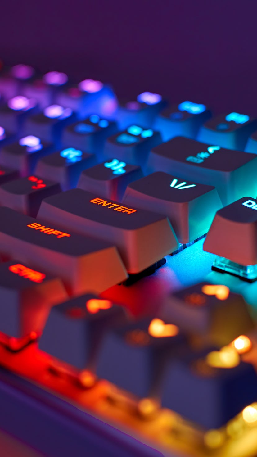 RGB gaming keyboard. Bright colorful keyboard, soft focus. Mechanical keyboard with RGB light, blurr...