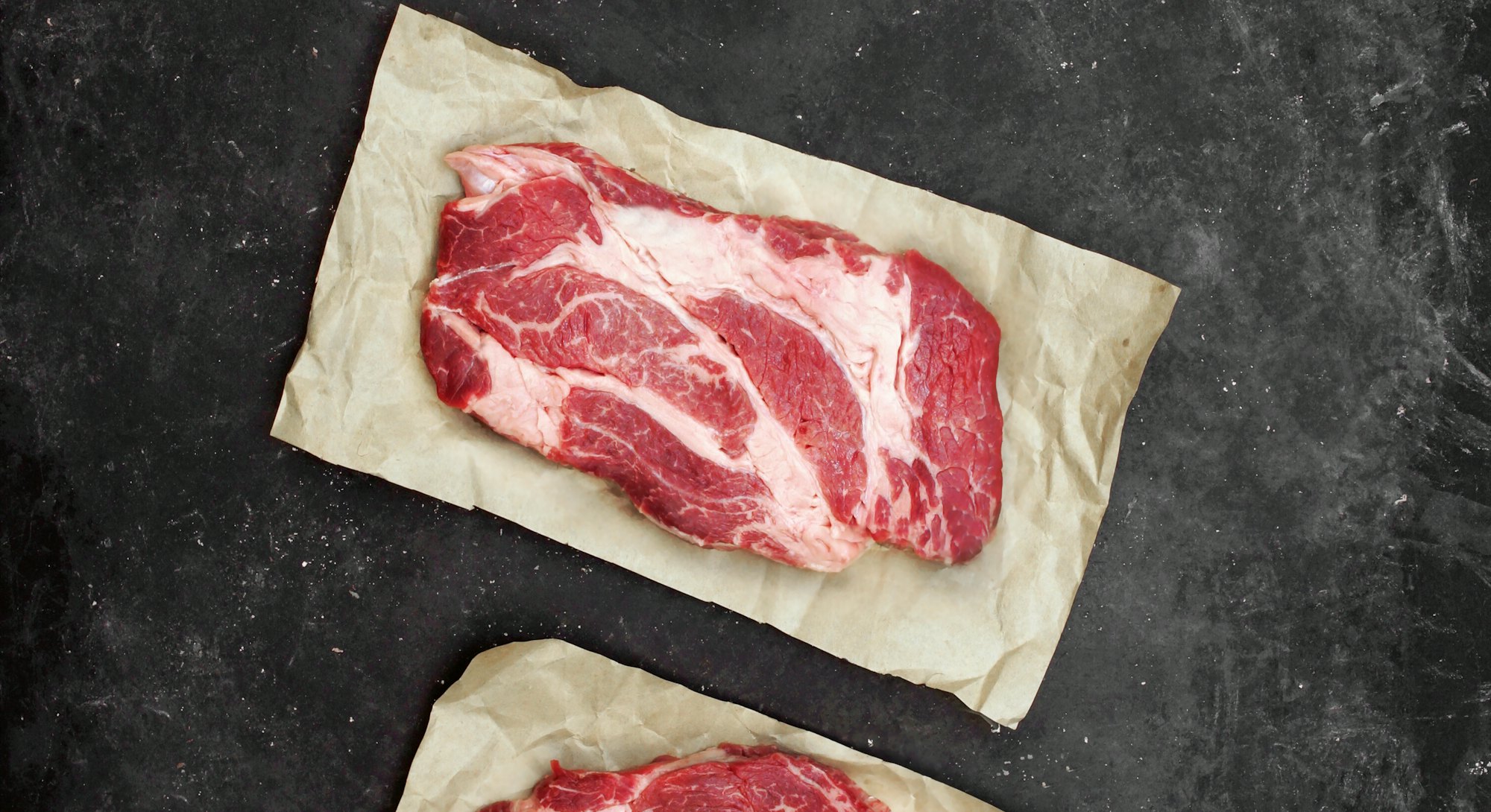 Raw Marbled Loin Beef Steaks On Brown Paper. Sirloin Beef Steaks, Overhead View. Three Raw Striploin...