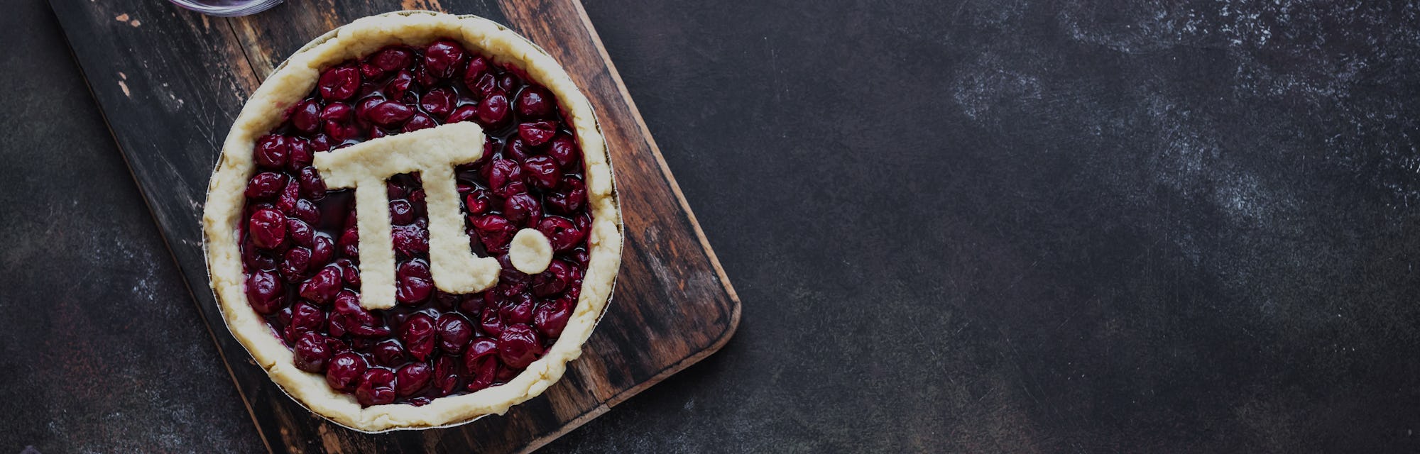 Pi Day Cherry Pie - making homemade traditional Cherry Pie with Pi sign for March 14th holiday, on r...