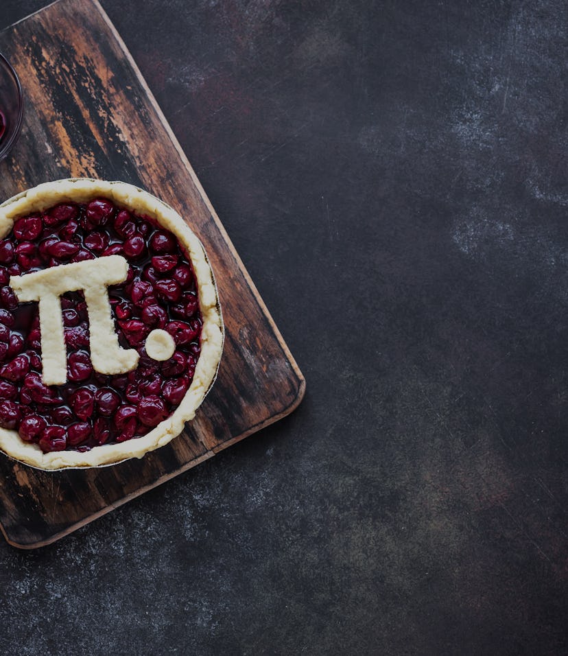 Pi Day Cherry Pie - making homemade traditional Cherry Pie with Pi sign for March 14th holiday, on r...