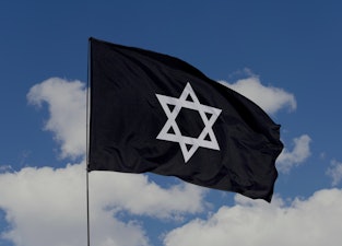 Judaism flag isolated on sky background with clipping path. close up waving flag of Judaism. flag sy...