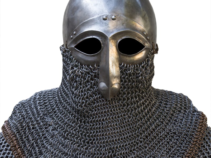 old knight helmet and chain mail for protection in battle. is made of metal. of knightly armor