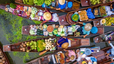 Aerial view famous floating market in Thailand, Damnoen Saduak floating market, Farmer go to sell or...