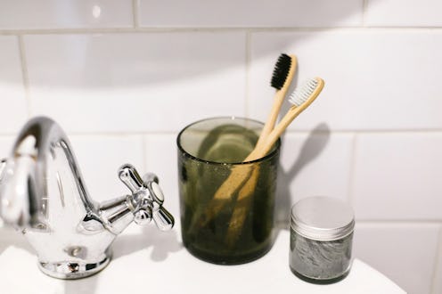 A charcoal-infused toothbrush. Dentists explain what to know about charcoal toothpaste's benefits an...