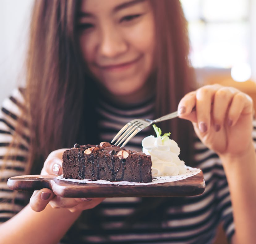 Woman holding a cake she made using a milk recipe when she had too much.