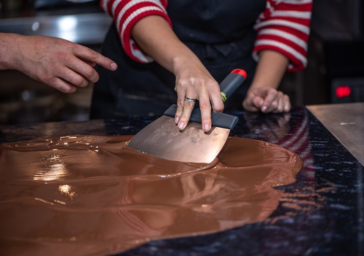Tempering melted chocolate on table