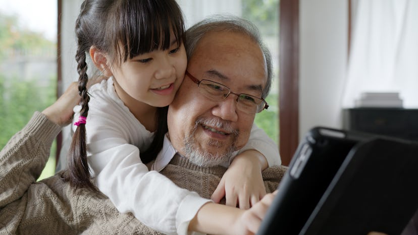 grandpa and granddaughter looking at computer for Grandparents' Day poems