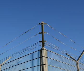 Barbed wire against a blue sky