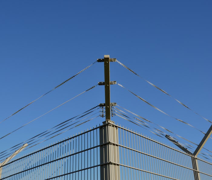 Barbed wire against a blue sky