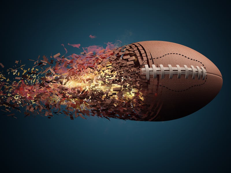 American football ball in fire flying