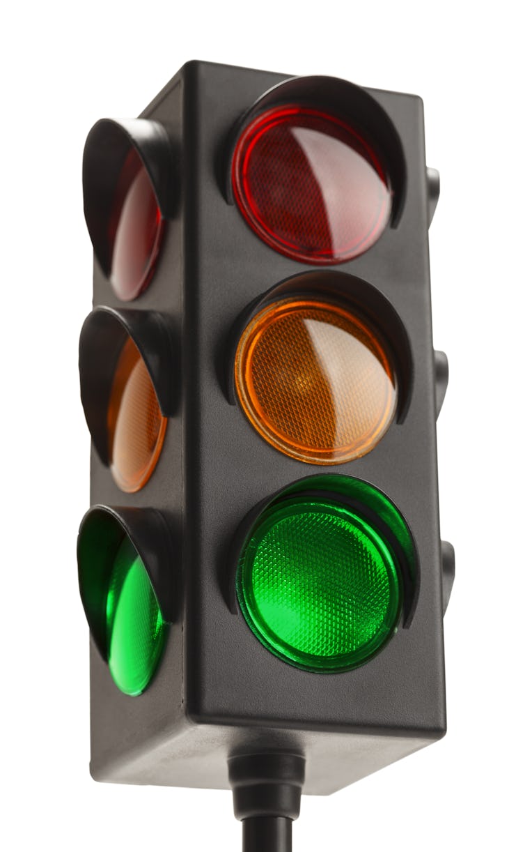 Stop Light With Green Go Signal Isolated on White Background.