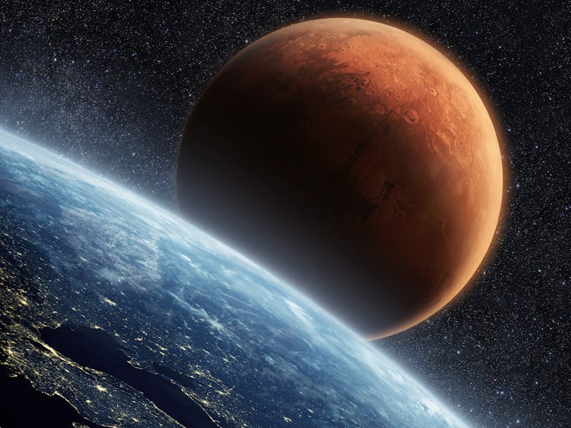 Blue planet earth with lights of night cities, view from space. Red Planet Mars in the starry sky. T...