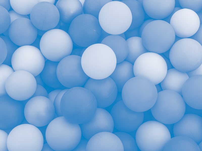 Full frame of multicolored plastic balls in the ball pit (ball crawl). Lots of colorful balls for ch...